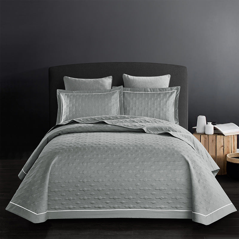 Purple quilt set with matching pillows on a white background