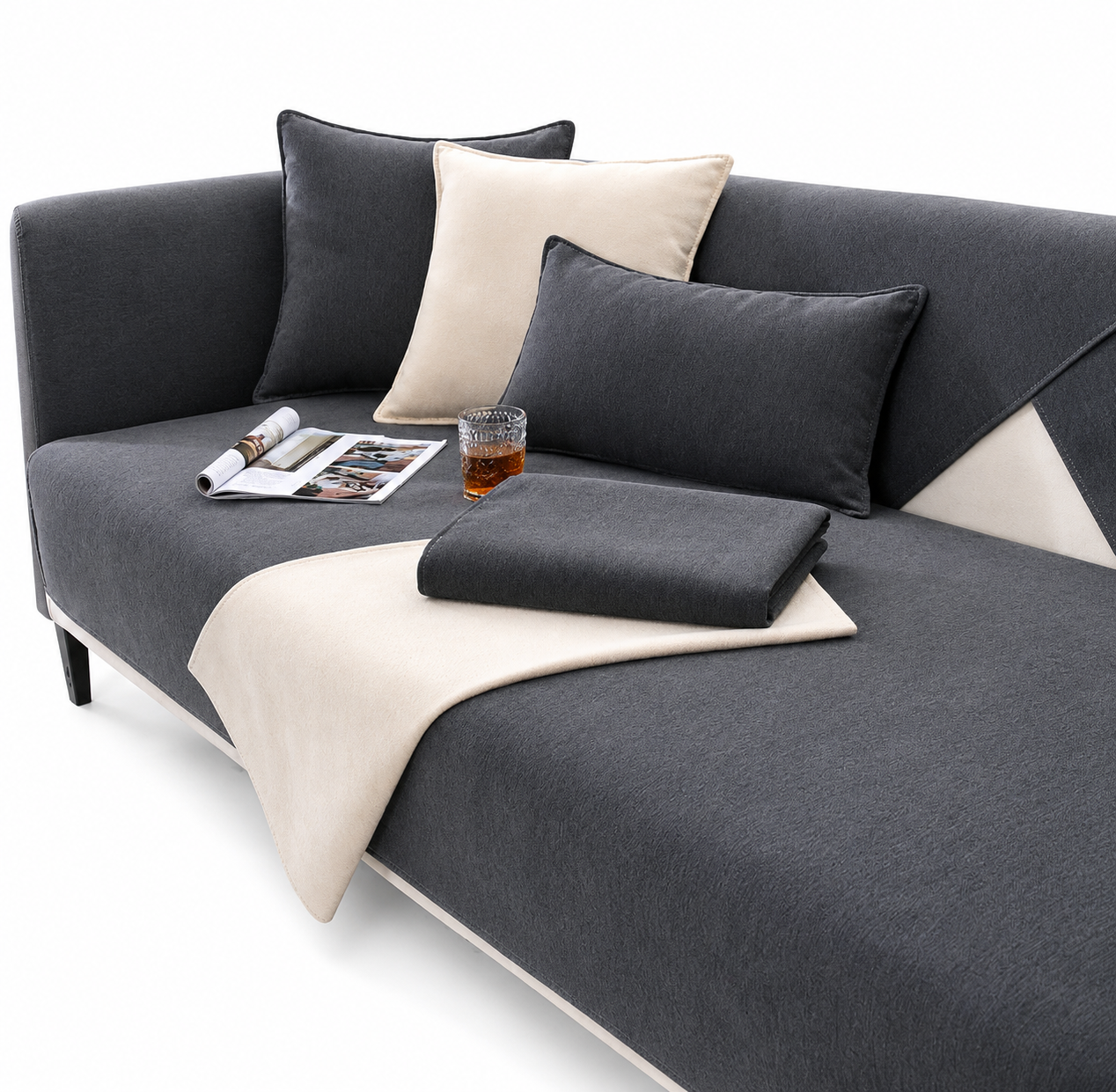 Gray sofa with cushions and a blanket on a white background