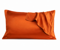 Orange satin pillowcase on a white background