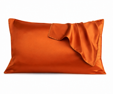 Orange satin pillowcase on a white background