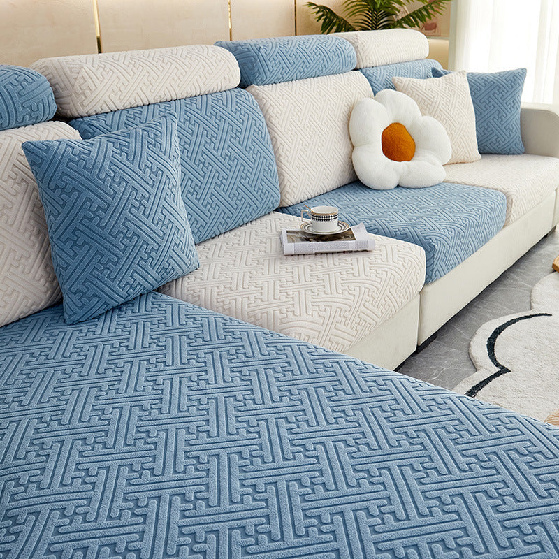 Blue and beige sectional sofa with decorative pillows on a white background