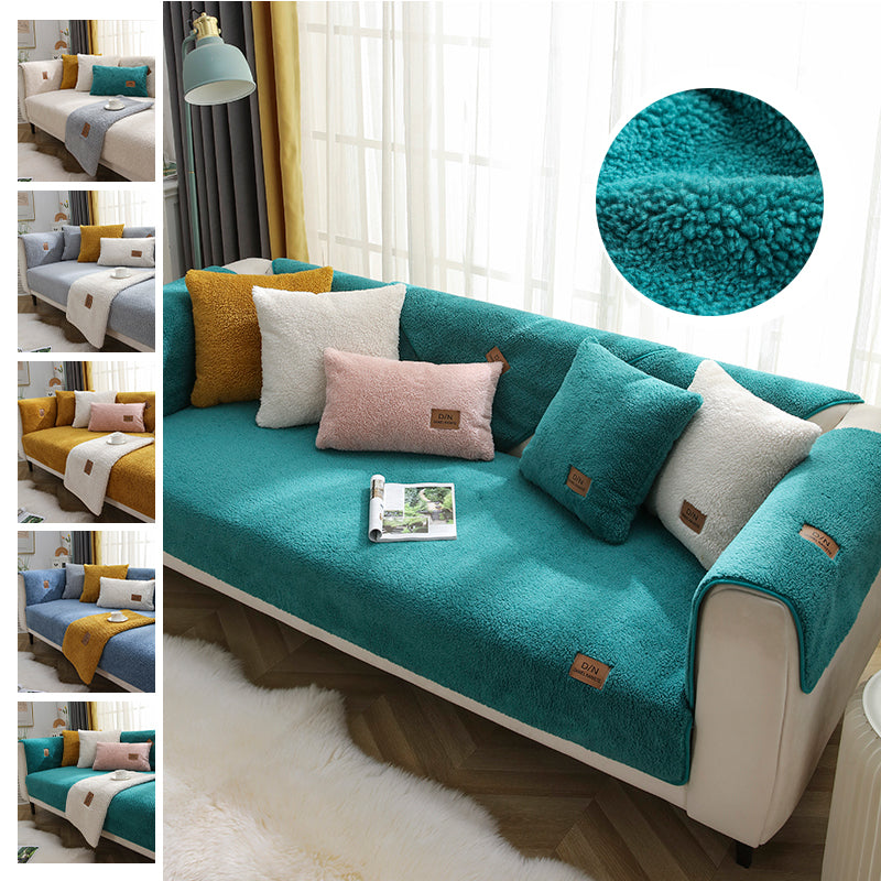 Teal sofa with colorful cushions on a white background