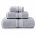 Set of three gray towels with striped patterns on a white background